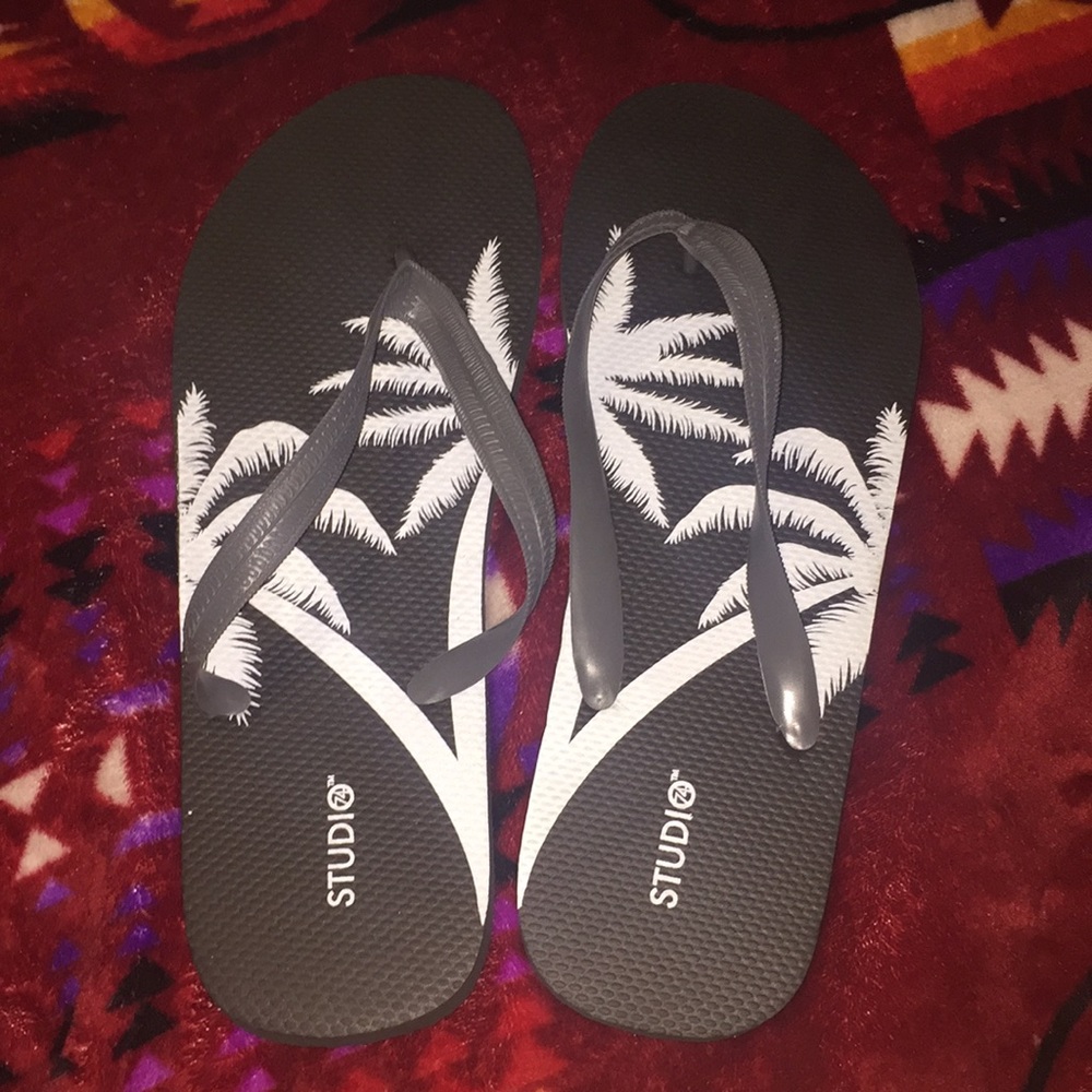 Black tropical flip flops